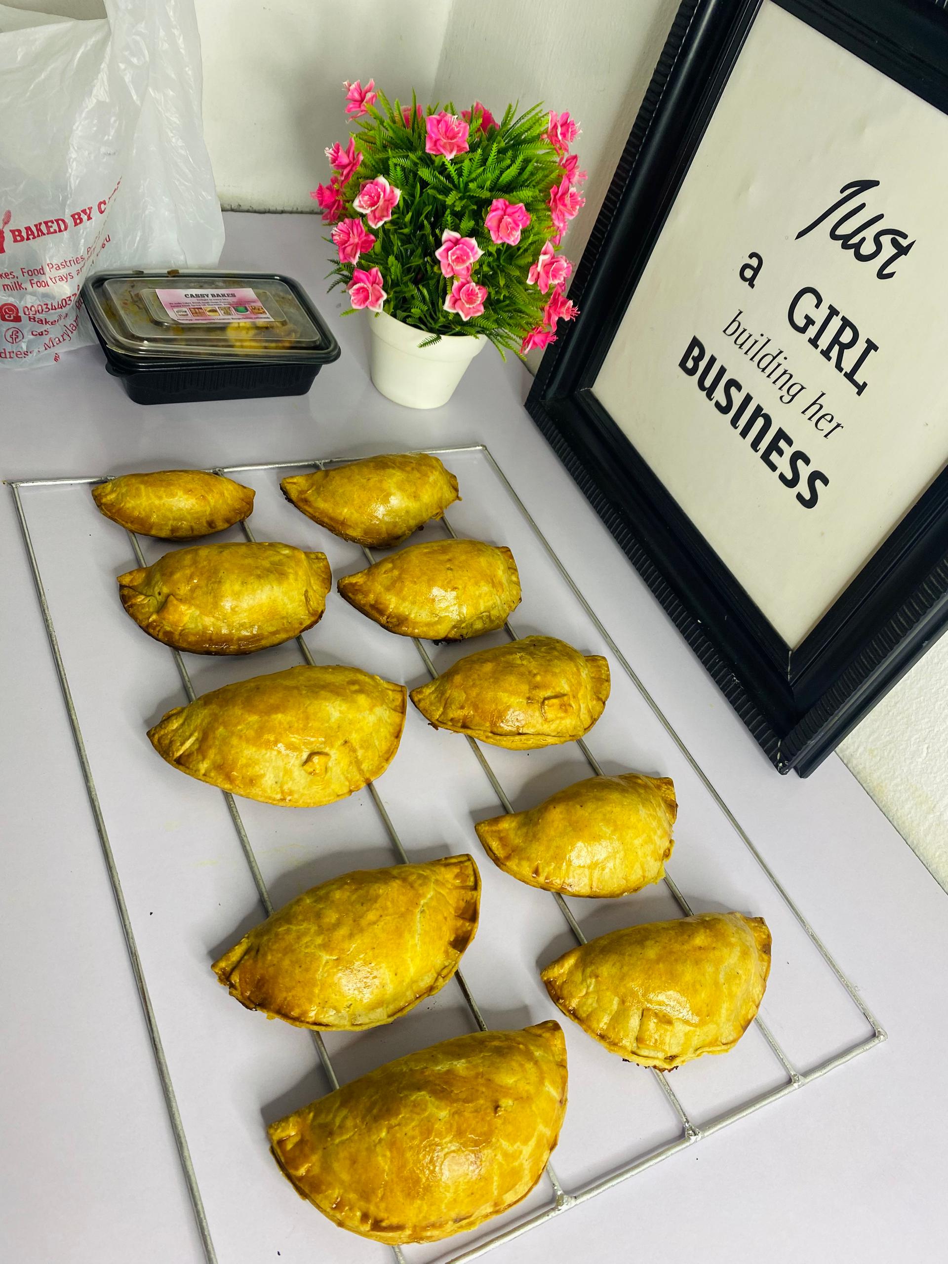 Golden meat pies on cooling rack