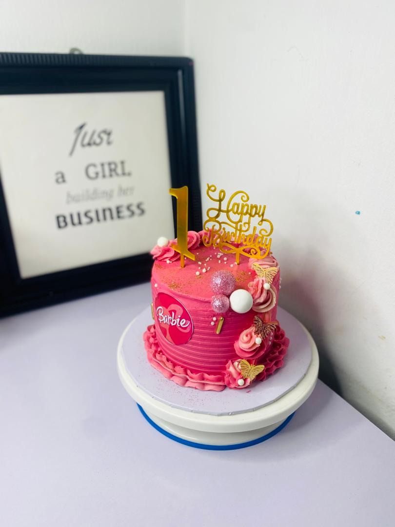 Pink Barbie 1st birthday cake with decorations
